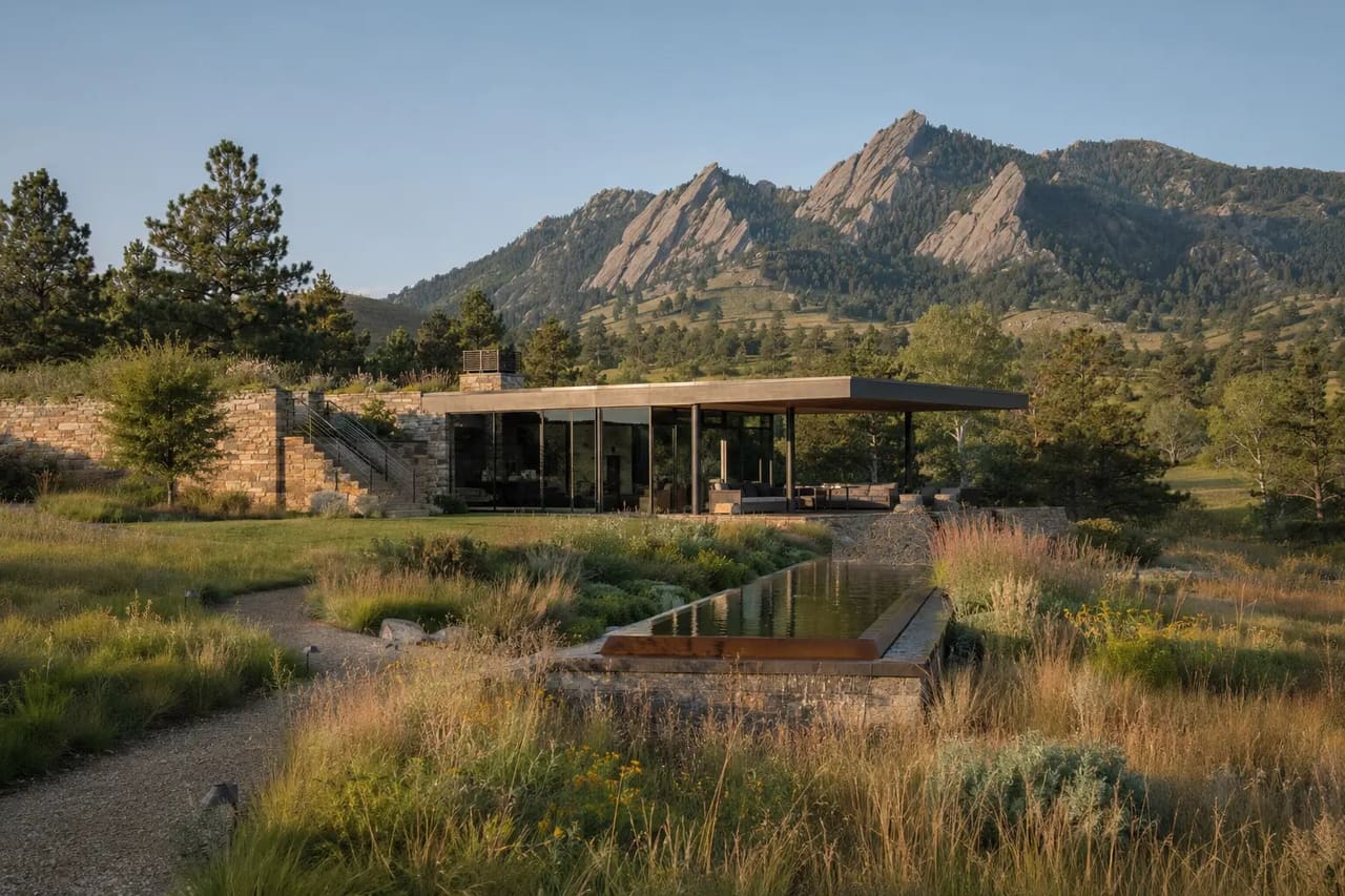 Illustrative low-profile Boulder foothill pavilion in native meadow beside a restrained water feature