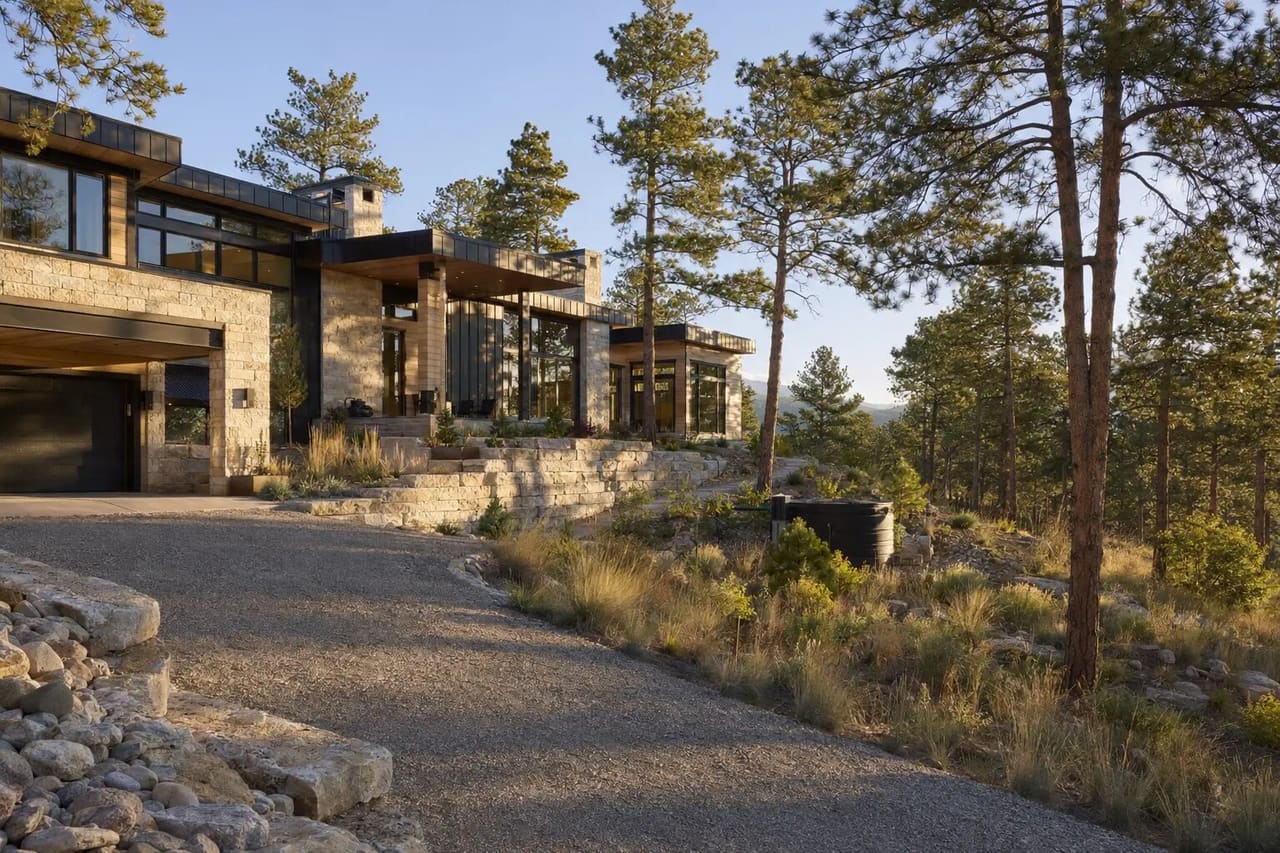 Illustrative Colorado foothill estate with mineral zones, spaced pines, and wildfire-aware planting